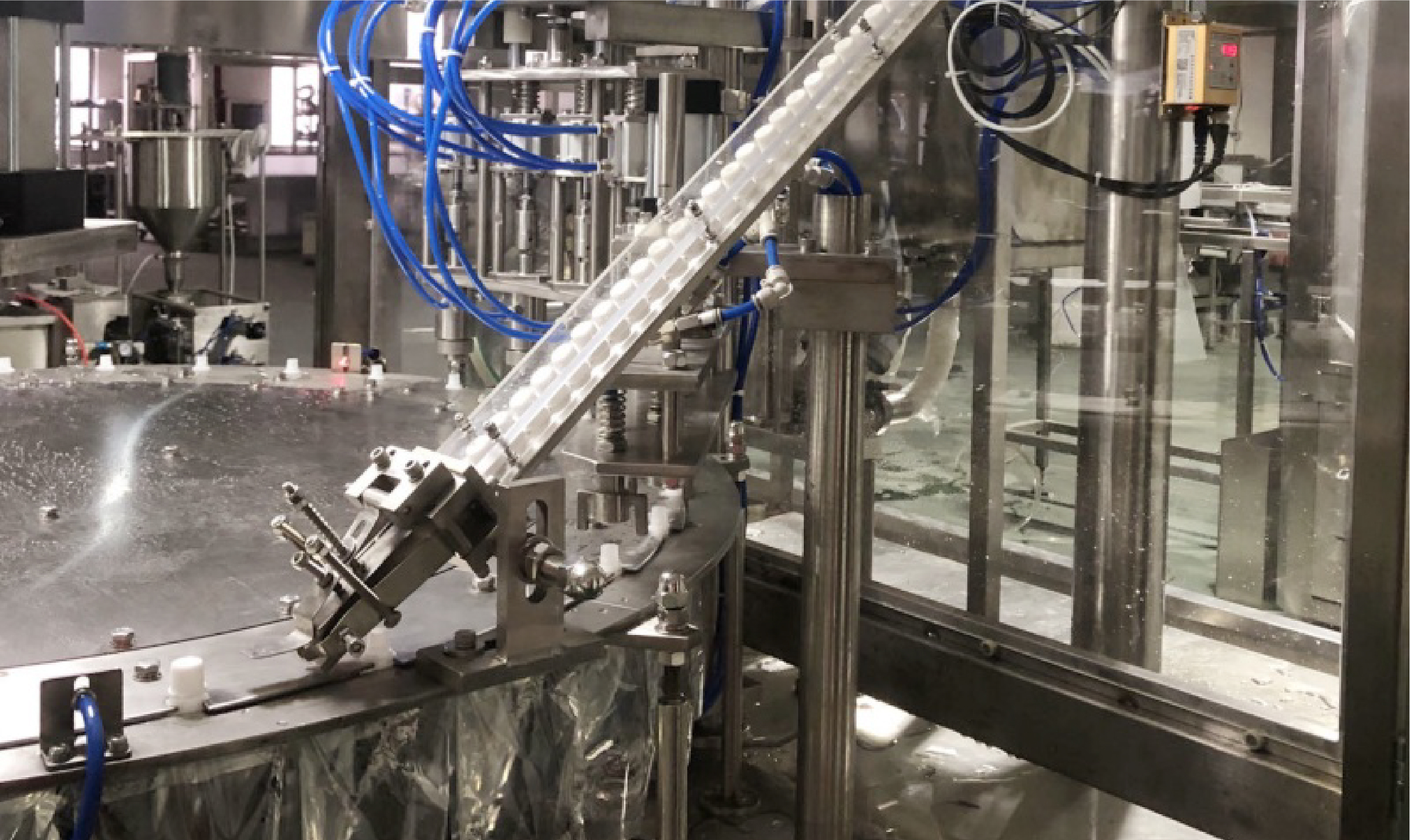 This spout pouch filling machine comes with automatic adjustable cap handling 
and tightening device, ensuring the cap is firmly tightened up.
